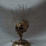 Image of a golden sculpture made of a skull
